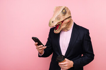 Lizard-headed man with a recyclable cardboard cup of coffee and smartphone.