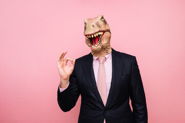 Man with euphoric lizard head and fingers with ok symbol