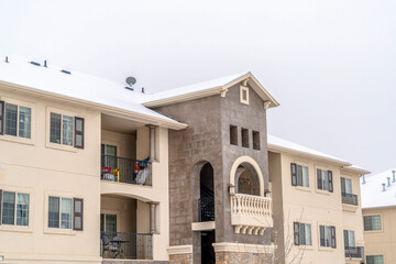 Front view of apartment building against a skyscape of white sky in winter