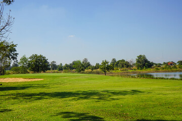 Beautiful golf course in a sunny day. Background evening golf course has sunlight shining down. Golf course in the countryside