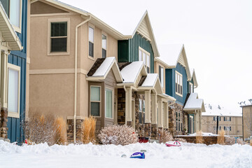 Neighborhood views with two storey apartment under cloudy sky in winter