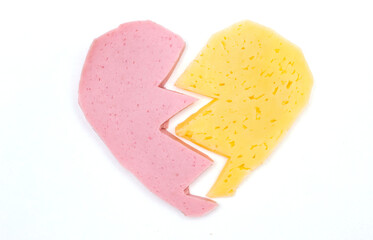 On a white background, sausage and cheese in the shape of a heart. The concept of Valentine's day.