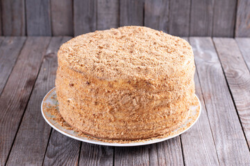 Layer honey cake Medovik on a wooden table. Traditional layer cake with honey cream