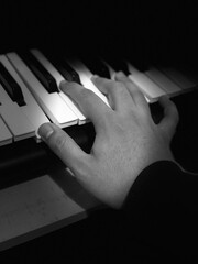 hands of a person playing piano