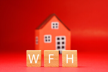 WFH or Work from home word object with blurred House on red background - work anywhere or from home ,  prevention of covid-19 virus concept 