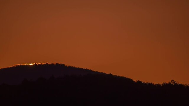 Big sun close-up rising at mountain.	 Beautiful nature video time lapse landscape.