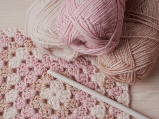 Fototapeta na wymiar Needlework crochet, top view of yarn balls, flat spoon on light wood close-up