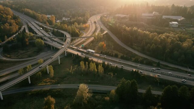 Aerial View of Freeway Junction Ramps Intersecting with Golden Hour Sunset Glow