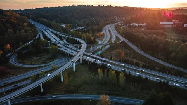 Drone Hyper Lapse Over Ramps of Freeway Intersect in Fall Season Sunset
