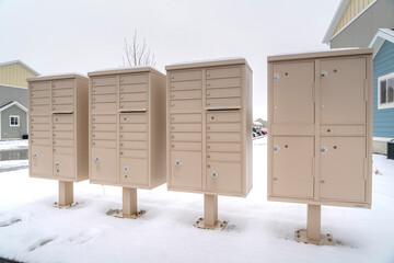Cluster mailboxes with compartments for residents of a snowy neighborhood