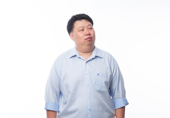Asian fat man in blue shirt thinking and looking to copyspace isolated on white background.