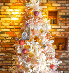 Seasonal background with Christmas bauble ornament on White christmas decoration tree. Celebration concept. Vertical photo