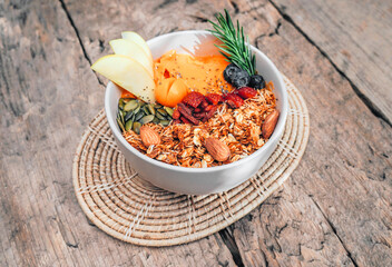 Breakfast Detox yellow Smoothie bowls  from papaya and mango  with fruits, nuts, seeds and homemade granola and strawberry, blueberry, apple, for healthy vegan vegetarian.