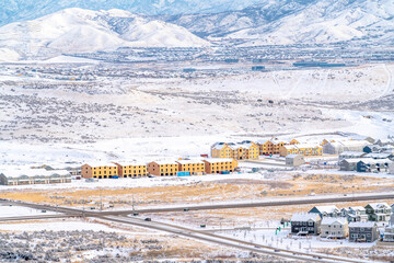 Apartments townhouses and homes on a snowy landscape with scenic mountain view