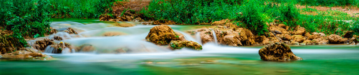 Colorful waterfall landscape. Gurleyik stream with long exposure, Mihaliccik, Eskisehir, Turkey. Panoramic shot. High resolution sharp photo. Panorama banner.