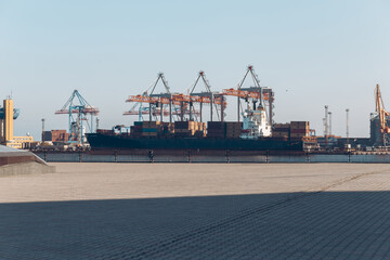 Yellow loading crane. Black Sea commercial port, container loading by crane. Shipping. Container...