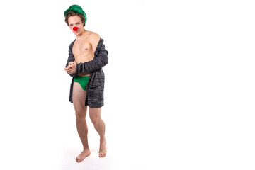 Funny guy in a clown costume. Holidays and fun. Young attractive man on a white background.