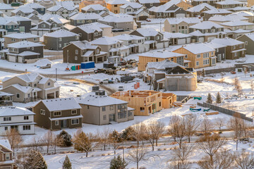 Fototapeta premium Neighborhood landscape in the sunlit snow covered valley terrain in winter