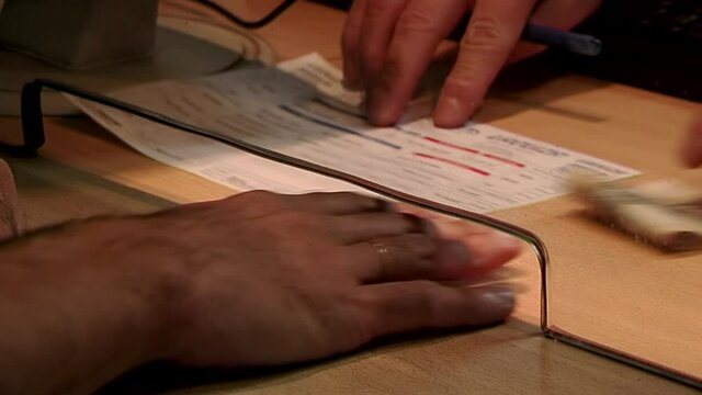 Man buying Intercity Bus Tickets at a Bus Station in Argentina. Close Up.  