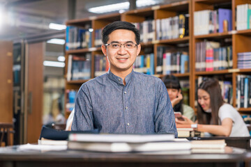 Portrait Asian teacher sitting in the library and classroom, University education, back to school...