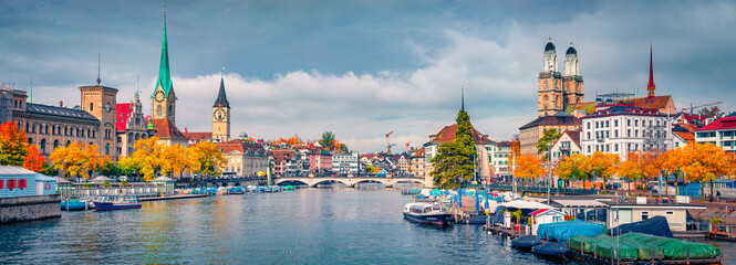 Beautiful autumn scenery. Panoramic morning view of Fraumunster and Grossmunster Churches. Splendid autumn cityscape of Zurich, Switzerland. Morning on Limmat River.