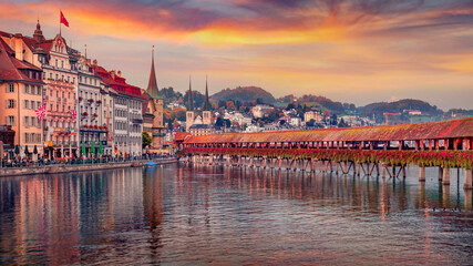 Splendid evening view of famous old wooden Chapel Bridge (Kapellbrucke), landmark 1300s wooden bridge. Picturesque Lucerne cityscape, Switzerland, Europe. Traveling concept background..