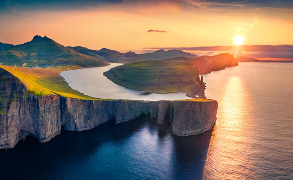 Magnificent evening view from flying drone of Sorvagsvatn lake, Vagar, Faroe Islands, Denmark, Europe. Majestic summer sunset on Atlantic Ocean. Beautiful summer scenery..