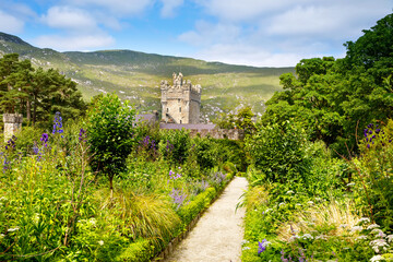 Naklejka premium Glenveagh Castle, Donegal in Northern Ireland. Beautiful park and garden in Glenveagh National Park, second largest park of the country. Gleann Bheatha in Irish language