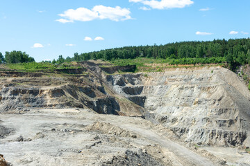 The production of graphite. Deep quarry for the extraction of minerals.