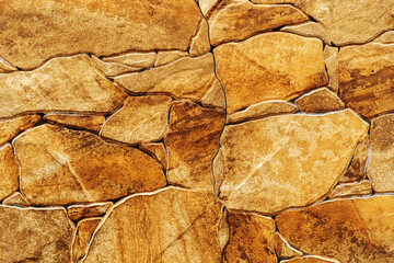 Decorative wall made of natural stone. Warm colors. Flat lay frame