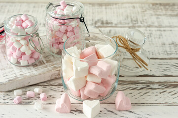 White and pink marshmallows for roasting and hot chocolate in a bowls, close up. Winter food background concept.