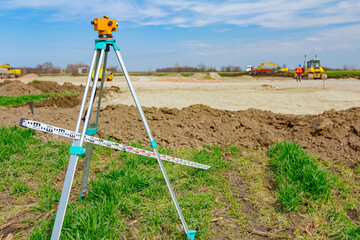 Geodesist device with leveling rod on tripod on a building site
