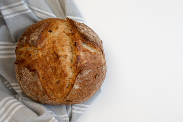 Fresh bread with gray tablecloth on white background.