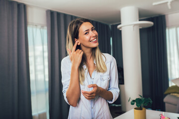 Fototapeta premium Head shot portrait smart confident smiling millennial woman standing at home.