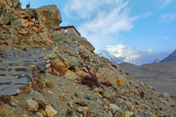 View of Mount Everest from the RongPu Monastery, at the Everest Base Camp in Tibet, against a blue sky.