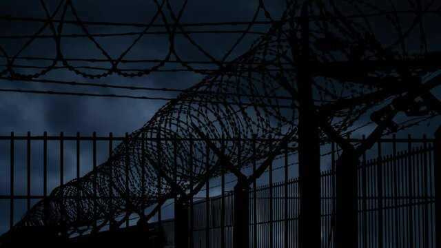 Wall of Barbed Wire and Mesh Steel with Lightning and Thunderstorm