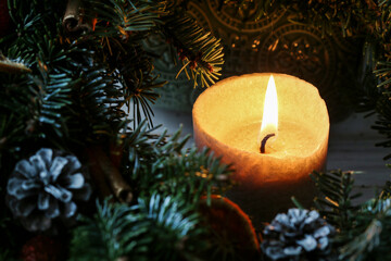 Christmas decoration with fir twigs, red apples, oranges, cones and cinnamon sticks