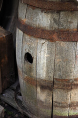 Old wooden barrel with hole and iron rims