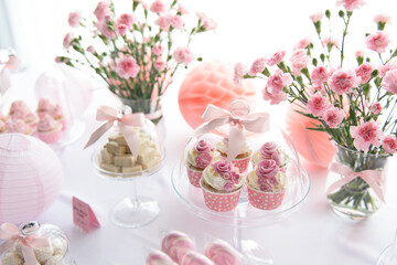 Cupcakes and other sweets on a sweet table at the wedding party