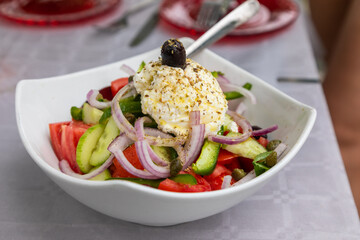 Healthy greek salad of fresh vegetables in plate.