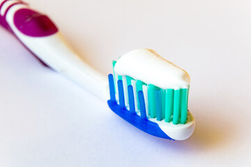 Toothbrush with toothpaste, traditional toothbrush close-up. Toothbrush head close-up. Oral hygiene.