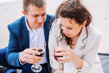 Happy just married middle age couple celebrate at beach with wine and have fun on summer day.