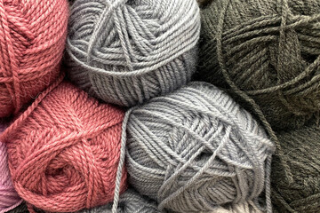 Yarn in skeins. Wool yarn of gray and pink colors lies tightly next to each other