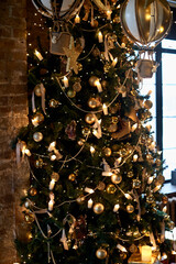 Close up of a decorated Christmas Tree with colourful decorations and garland lights, bokeh. Festive and New Year concept.