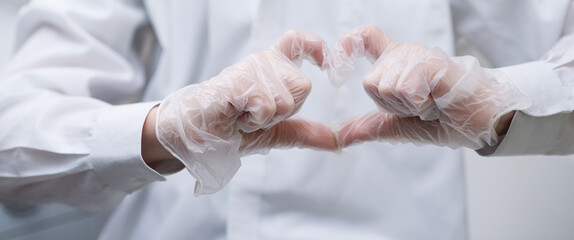 Fototapeta premium heart sign shown with gloved hands