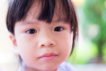 Head shot of upset child girl. Unhappy Asian children.