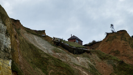 house collapsing from a cliff on the seashore, normandie