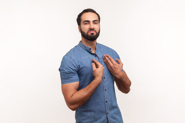 Arrogant egoistic bearded man drawing attention to itself, bragging with strength and endure, successful famous person posing at camera. Indoor studio shot isolated on white background