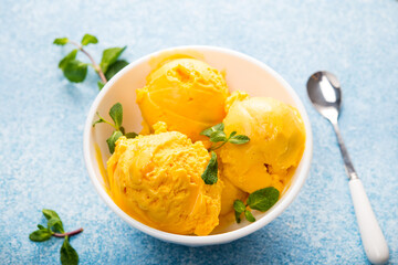 Mango ice cream, sorbet in a plate on a concrete backgroun