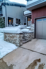 House exterior with attached garage on a snowy residential landscape in winter